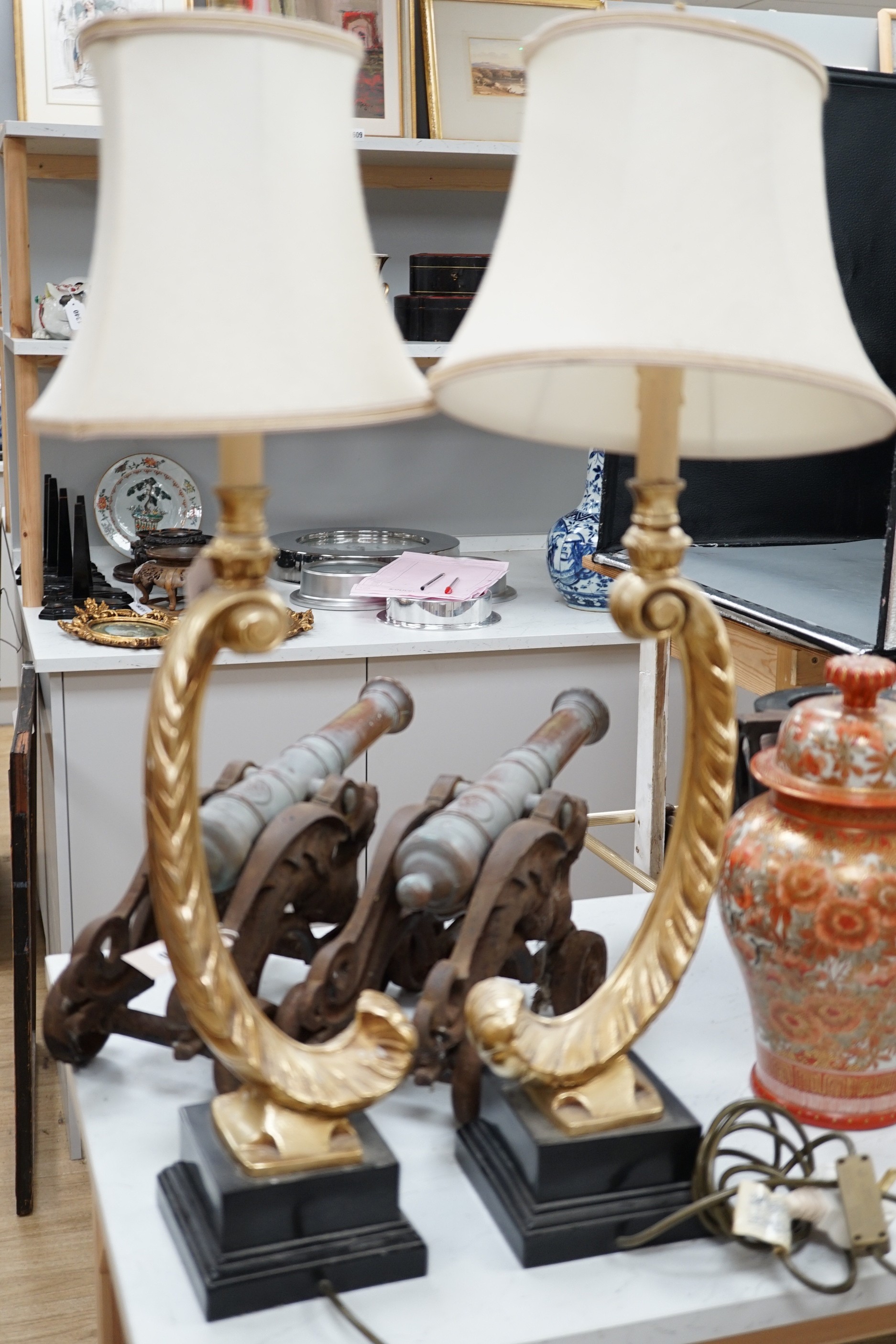 A pair of gilt resin feather table lamps. 72cm high